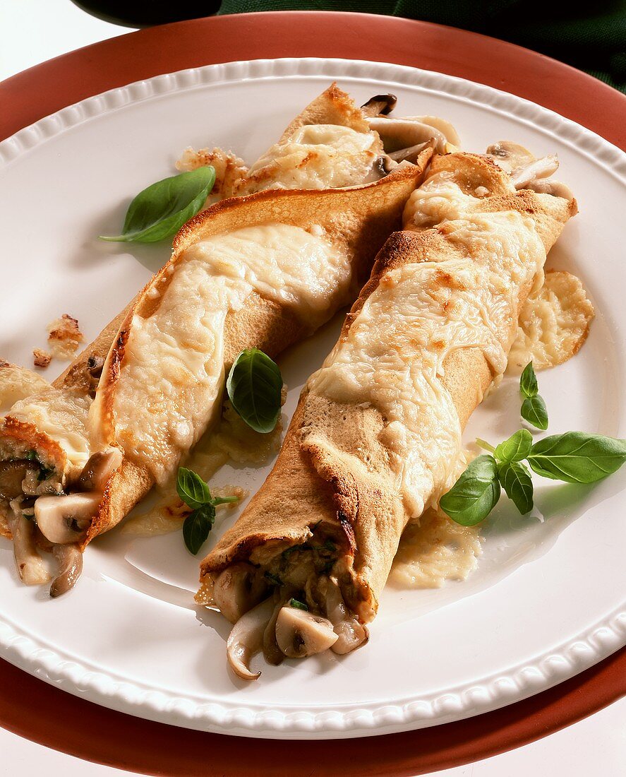 Crepe roll with mushroom filling & toasted cheese topping 