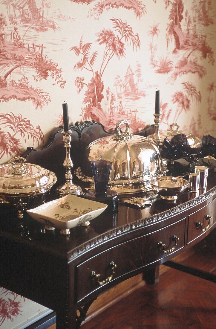 Silver dinner service on sideboard