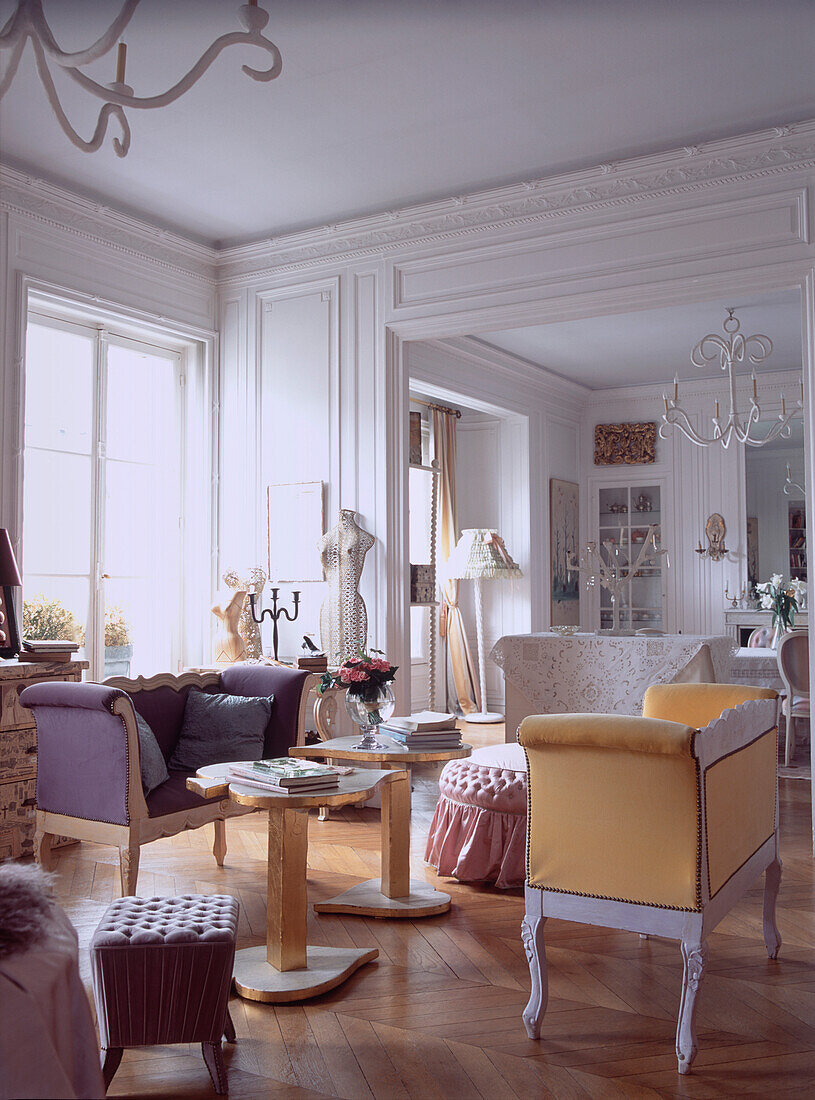 Elegant panelled drawing room with high ceilings with an eclectic mix of furniture on wooden parquet floor