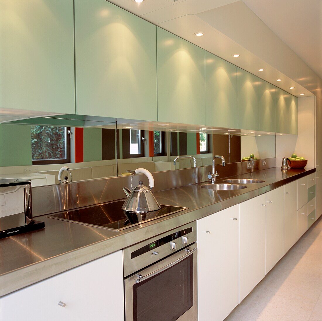 Modern kitchen units with mirrored splash-back