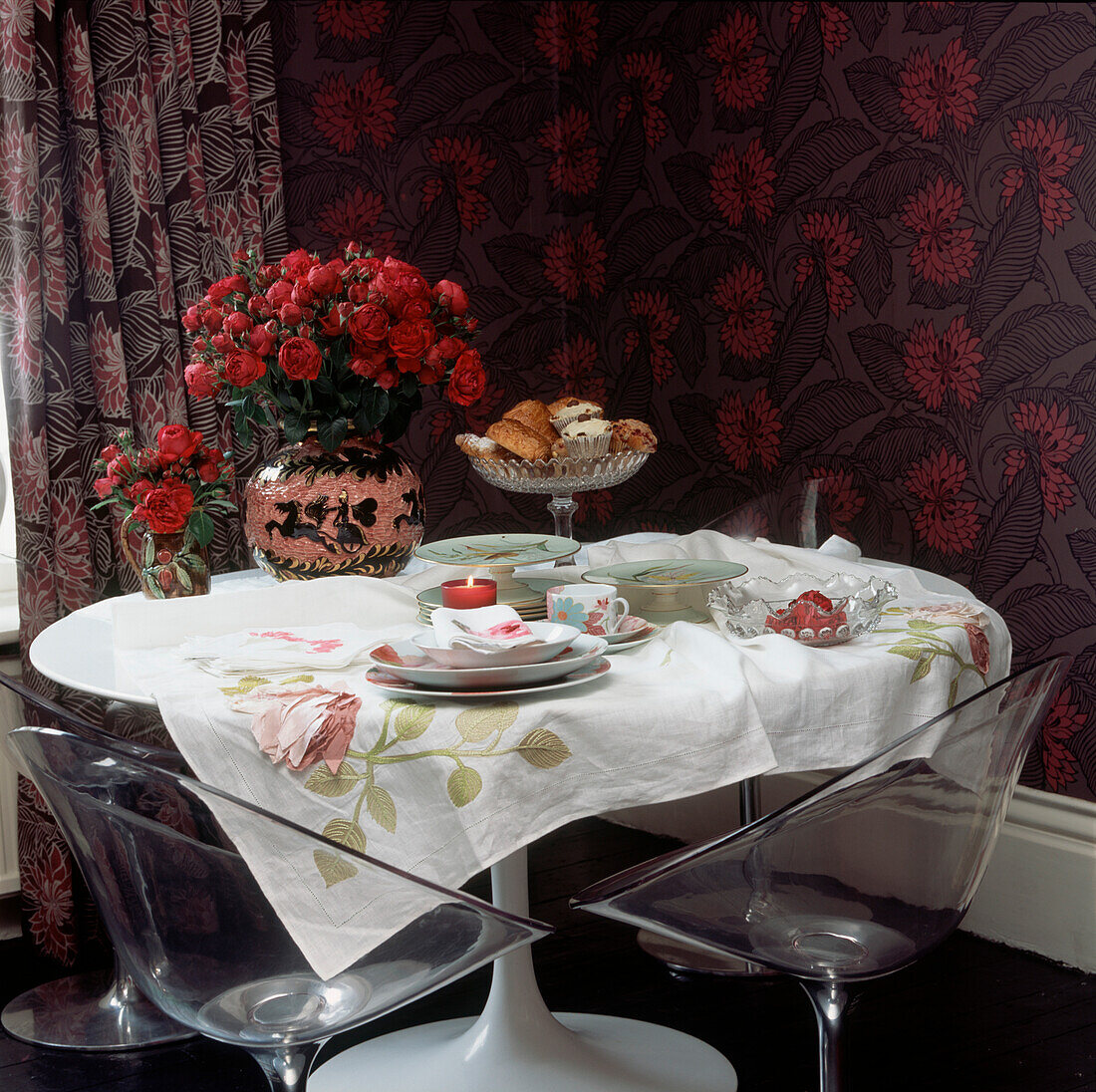 Feminine floral dining room with 70s plastic chairs