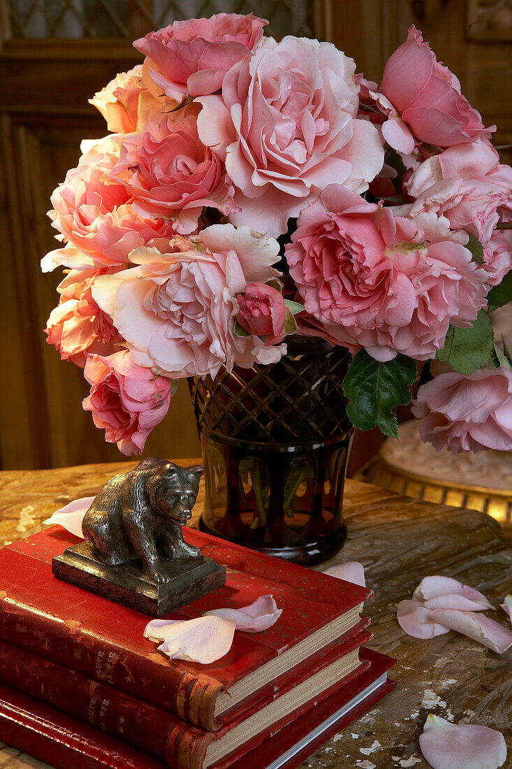 Still life with pink roses and books