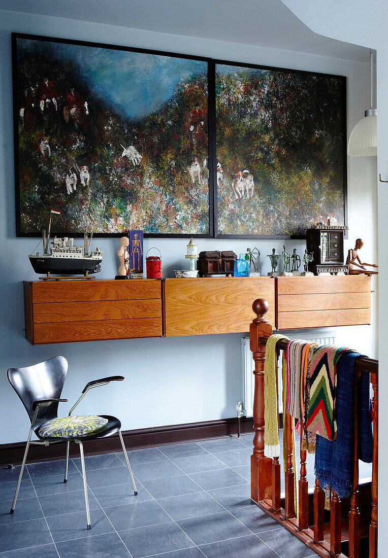 Landing with large artwork and wall hung drawers with group of nostalgic objects