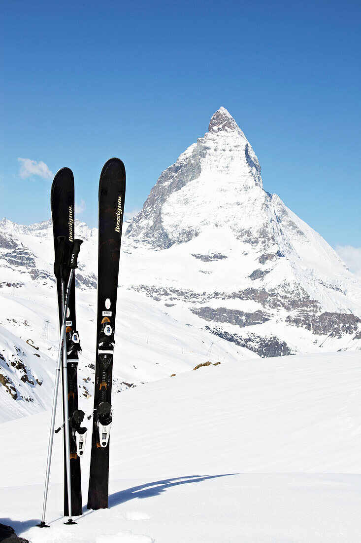 Skis and ski poles with view of Matterhorn in Zermatt, Valais, Switzerland