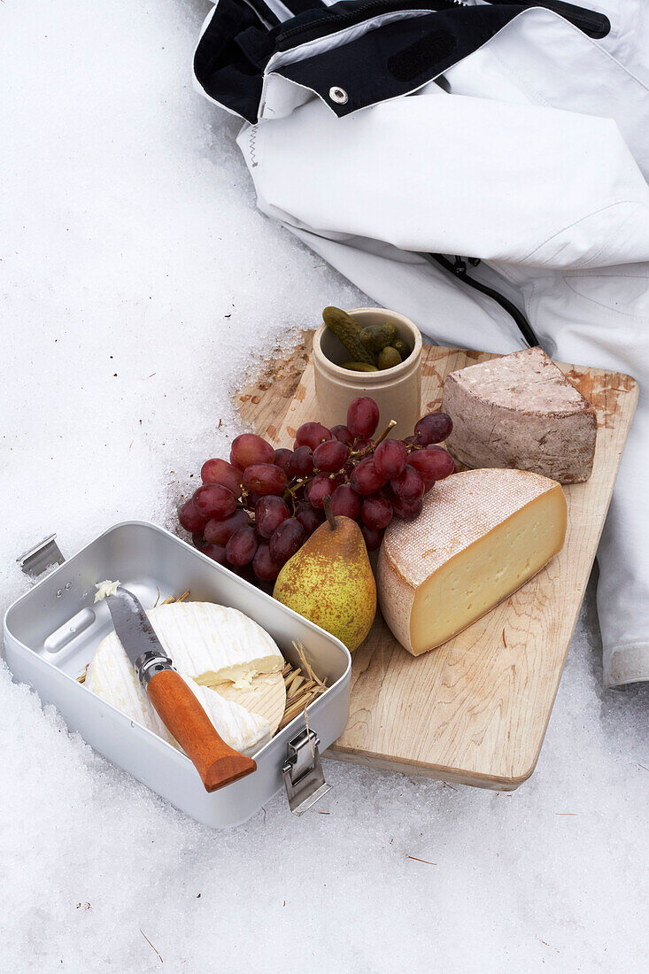 Selection of cheese and fruit with skiing jacket, Zermatt, Valais, Switzerland