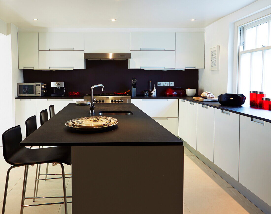 Contemporary dark wood kitchen in London townhouse, England, UK