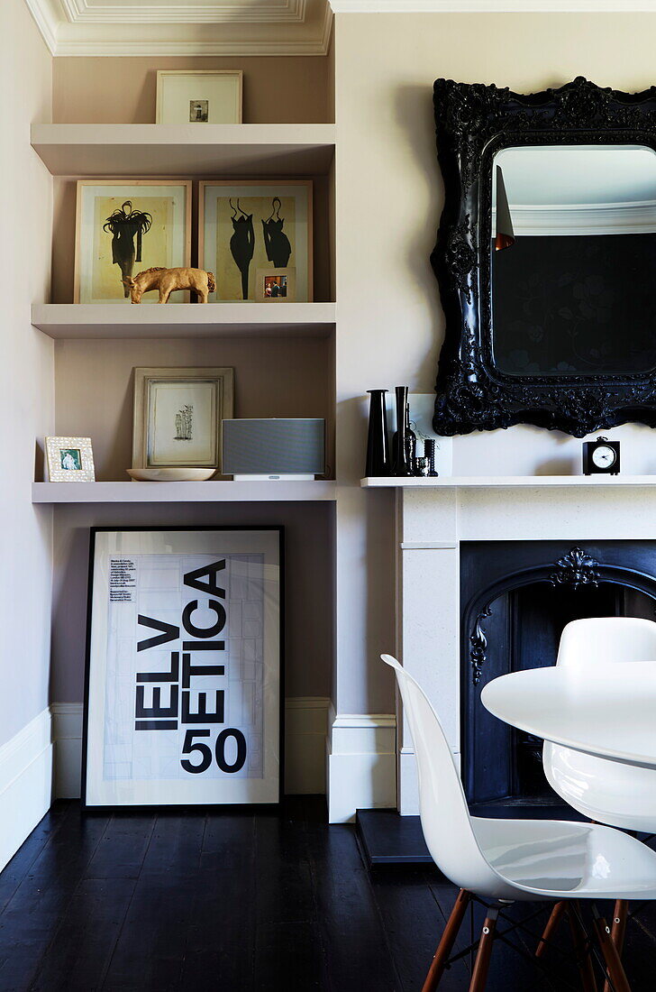 Dining room fireplace and shelving in London townhouse, England, UK