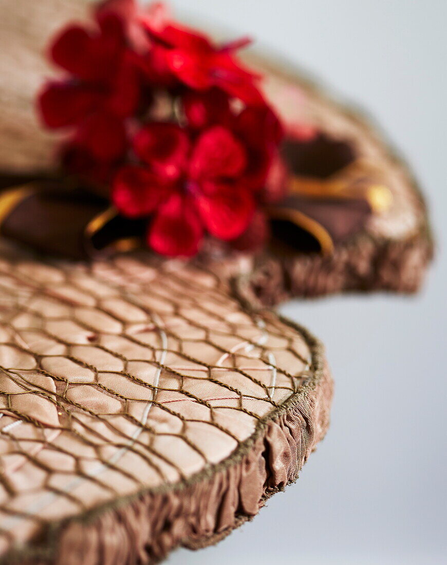 Red flowers and cushion detail in Cumbria home, England, UK