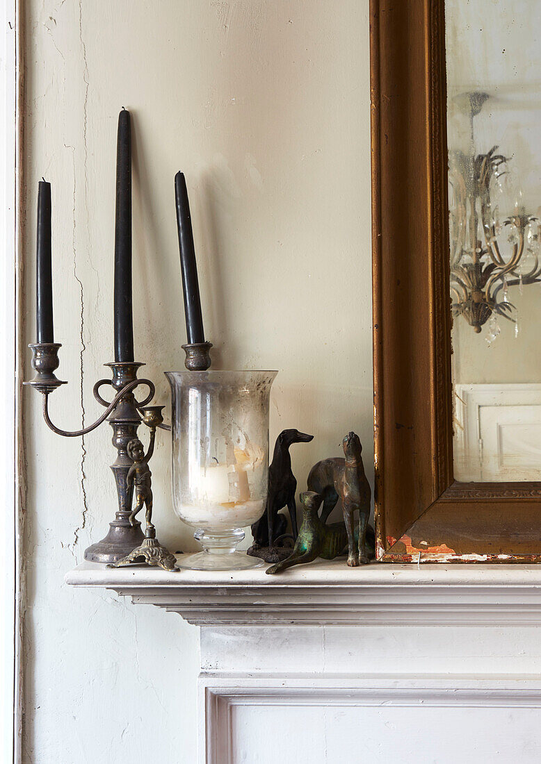 Metal dog figurines with candles on mantlepiece in Evershot home, Dorset, Kent, UK