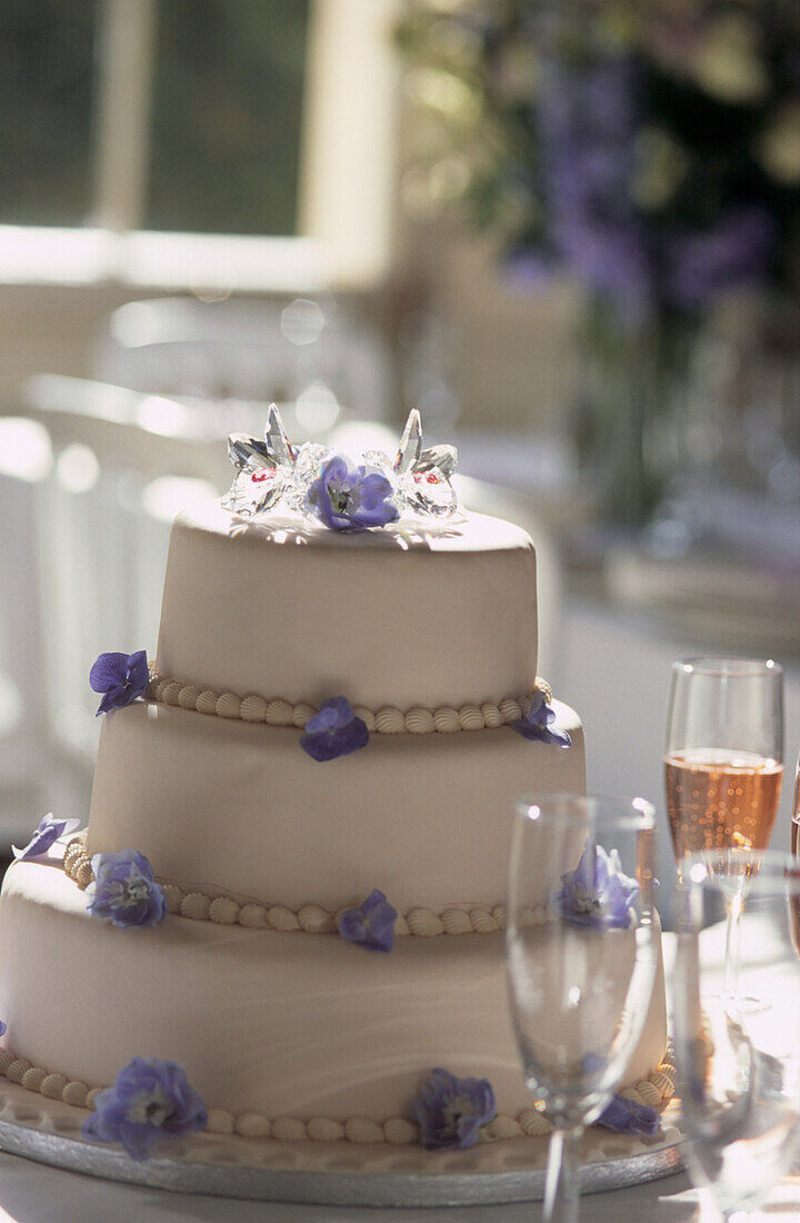 Hochzeitstorte mit lila Blumen verziert