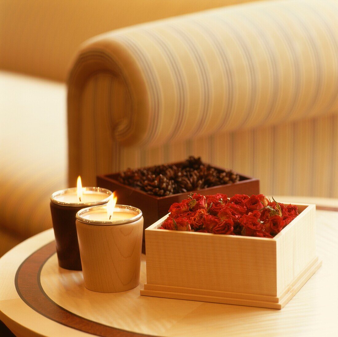 Pot pourri and lit candles on side table in living room