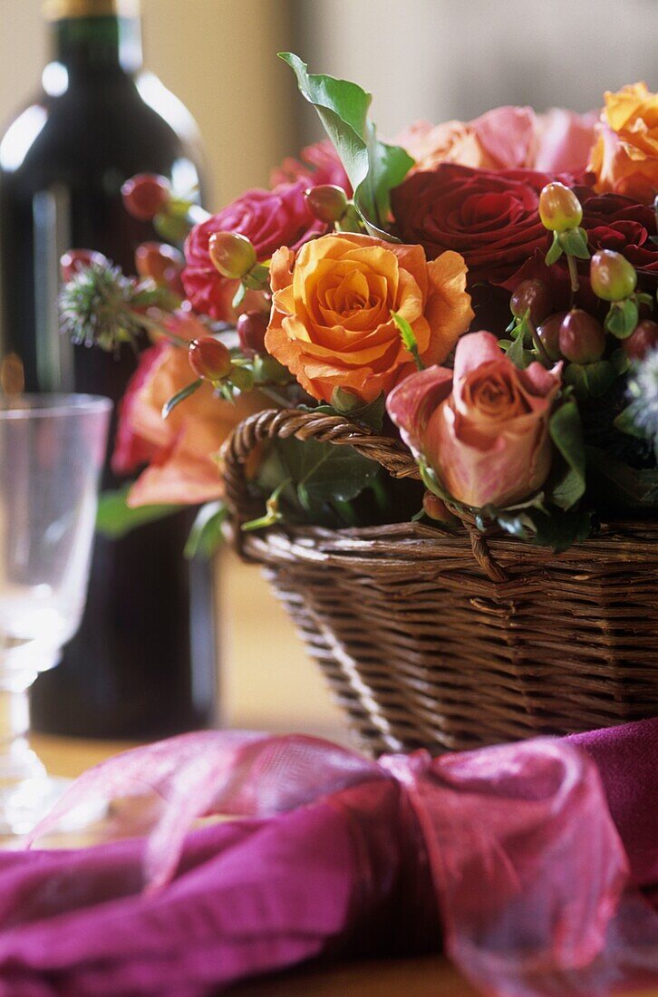 Flower arrangement with roses in the basket on the table