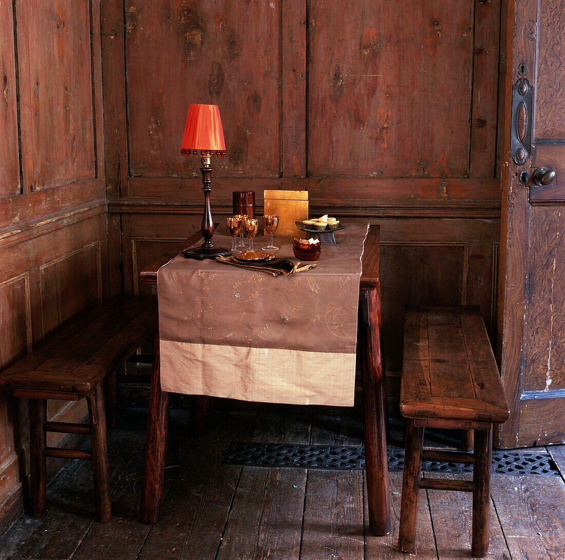 Wooden table and benches in rustic style house