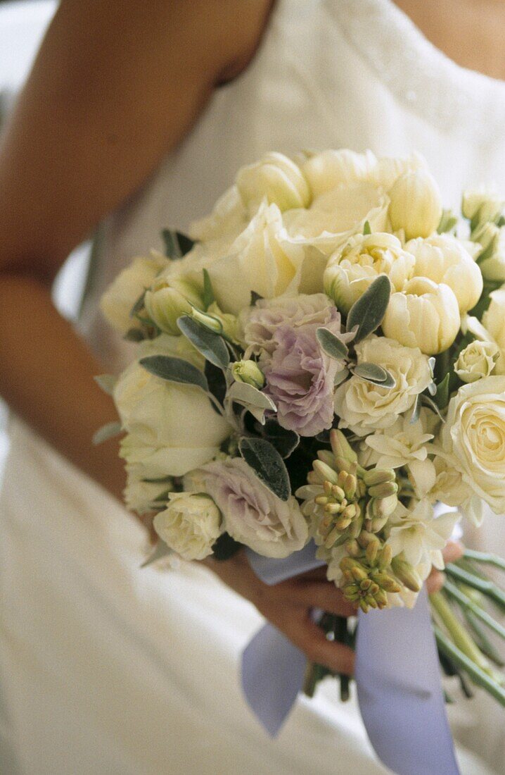 Bride holding white wedding bouquet