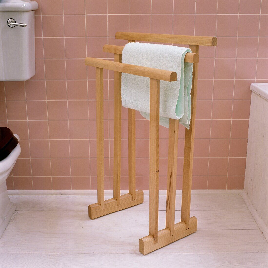 Towel rail in tiled pink bathroom