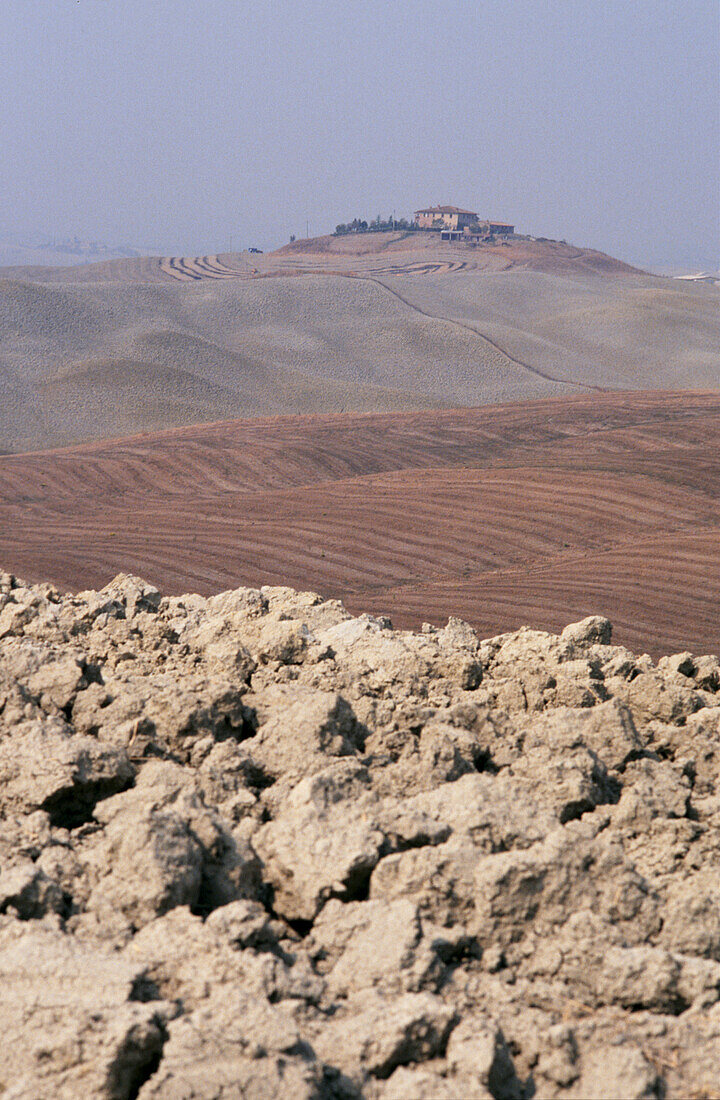 Hilltop farmhouse overlooking ploughed fields near Navarra in Rioja Spain 