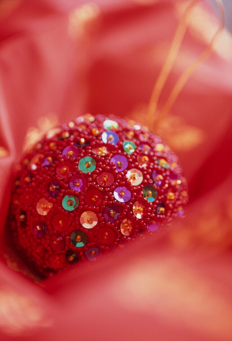 Close up of sequined red Christmas tree decoration