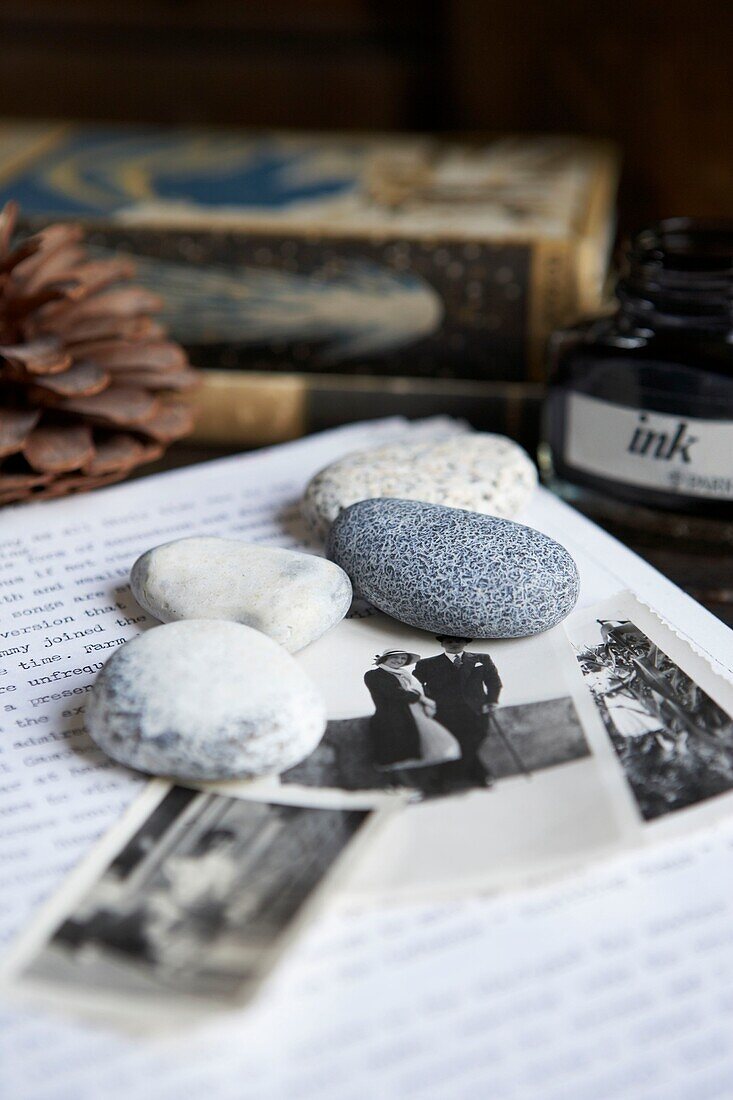 Desk with pebbles,a letter and some black and white family photos