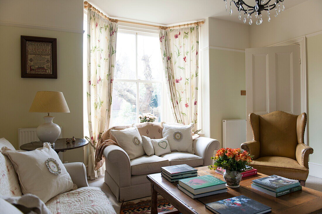 Leather wingback armchair with cream sofas in living room of Ashford home,  Kent,  England,  UK