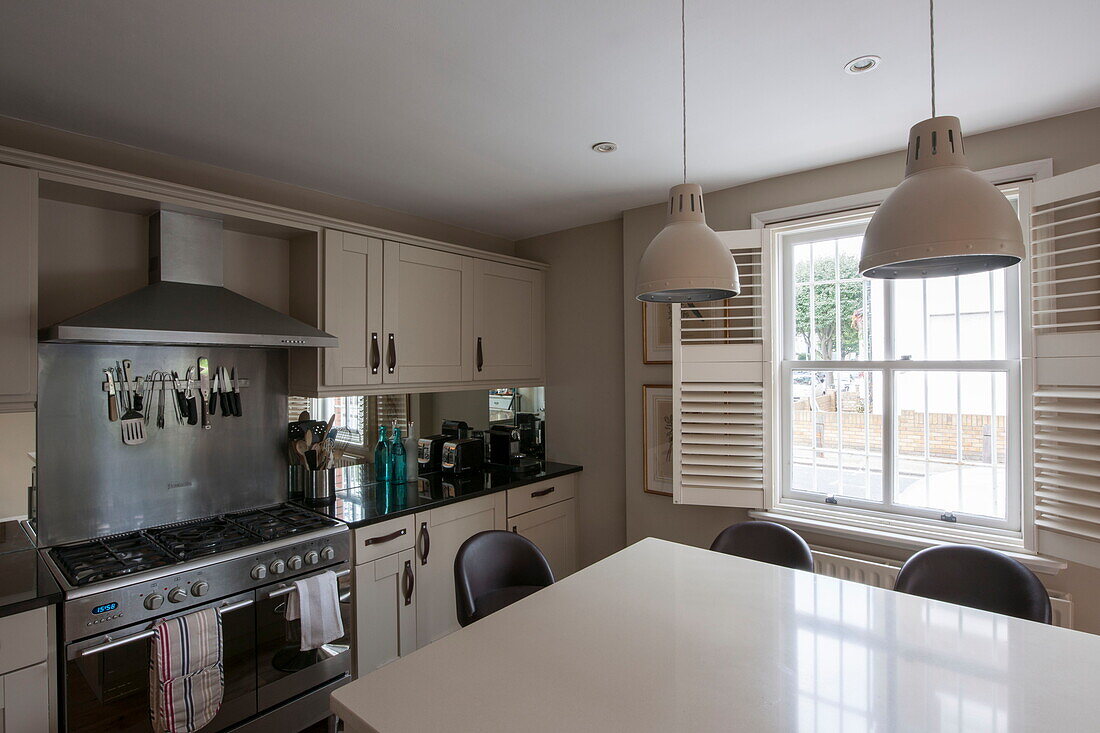 Aluminium range oven in cream kitchen of Battersea home,  London,  England,  UK