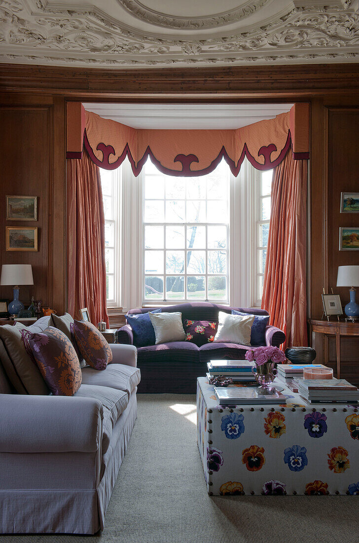Decorated coffee table and sofas in drawing room of Tiverton country home,  Devon,  England,  UK