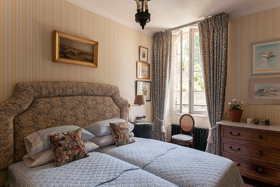 Floral headboard and cushions with quilted bed covers in Dordogne country house  France