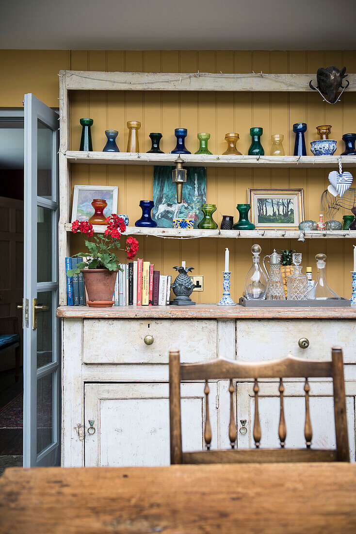 Glass vases on wooden dresser in kitchen of 18th century Surrey home  England  UK