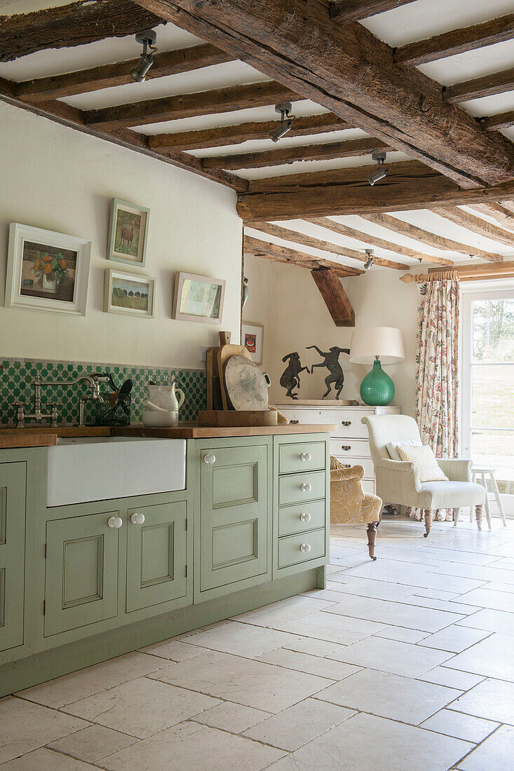 Belfast sink in light green fitted Suffolk farmhouse kitchen  England  UK