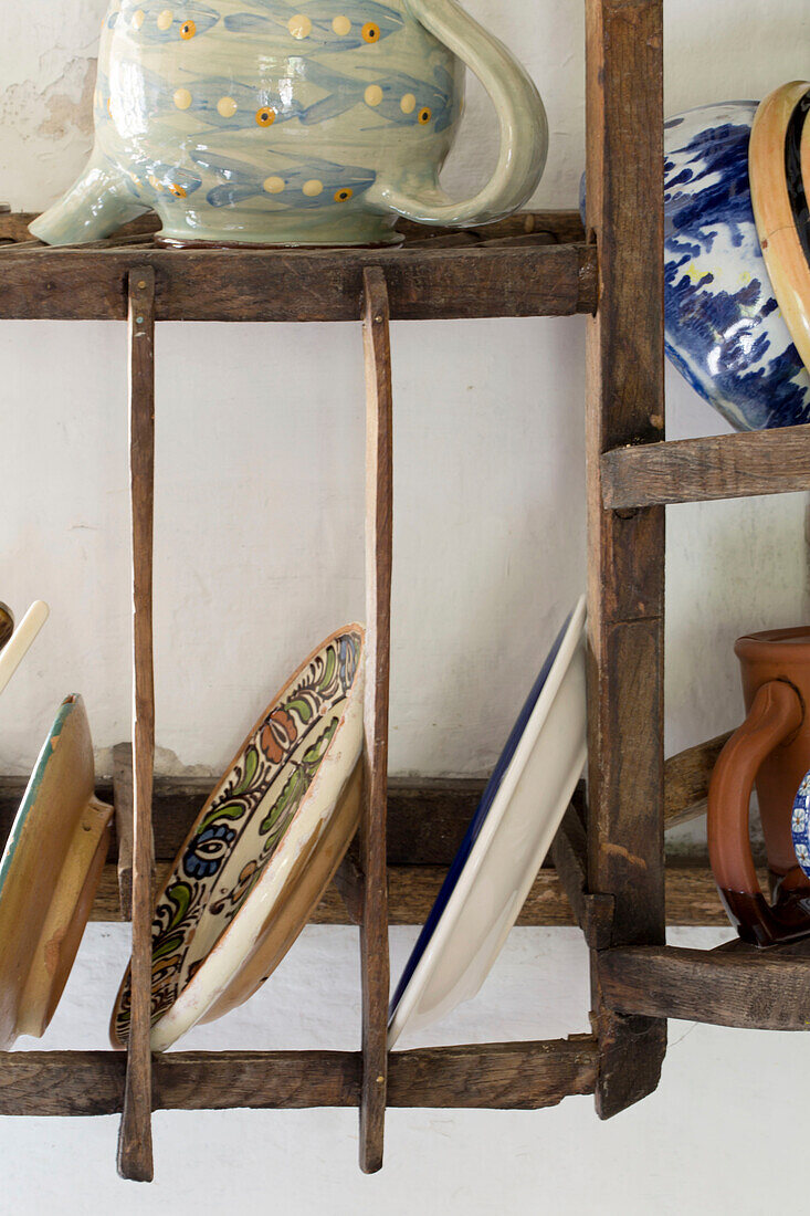 Kitchen crocker on wooden rack in Devon cottage England UK