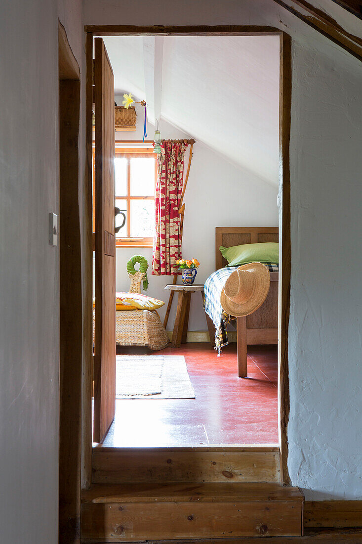 View through split-level doorway to bedroom of Devon cottage England UK