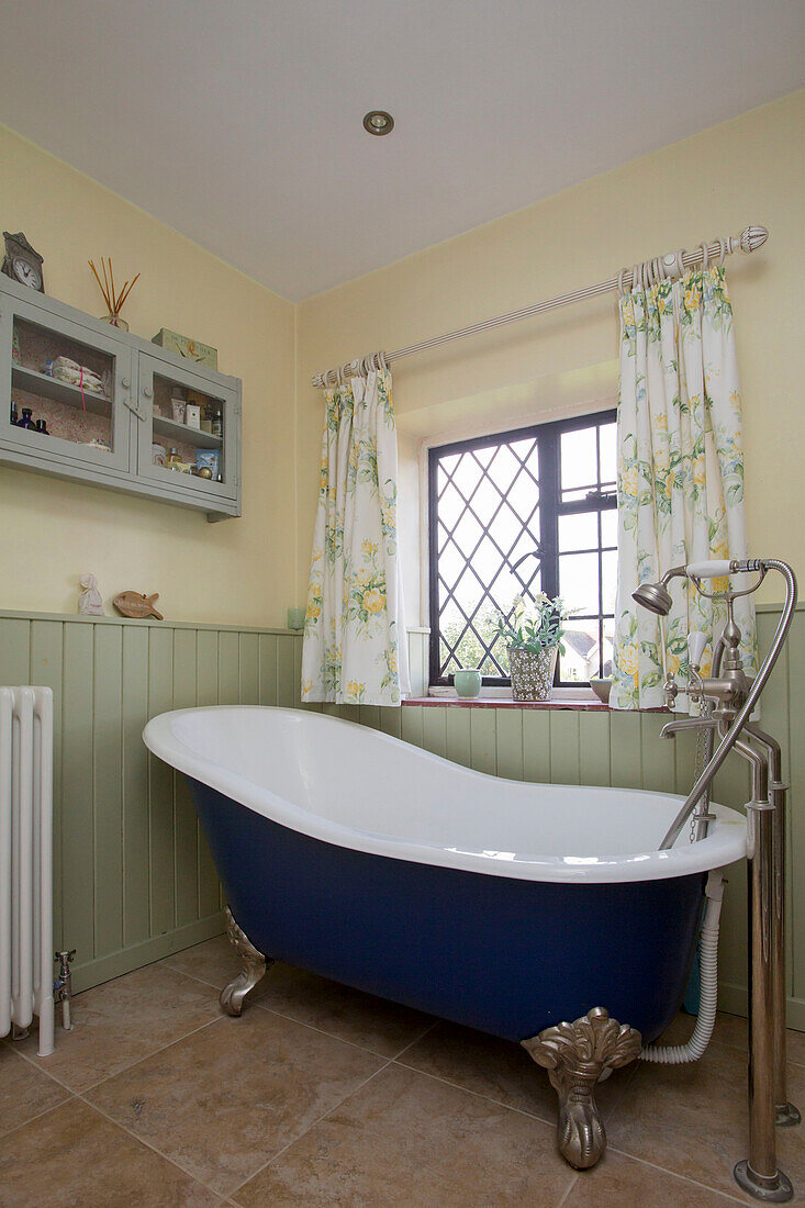 Freestanding bath at window of Amberley cottage West Sussex UK