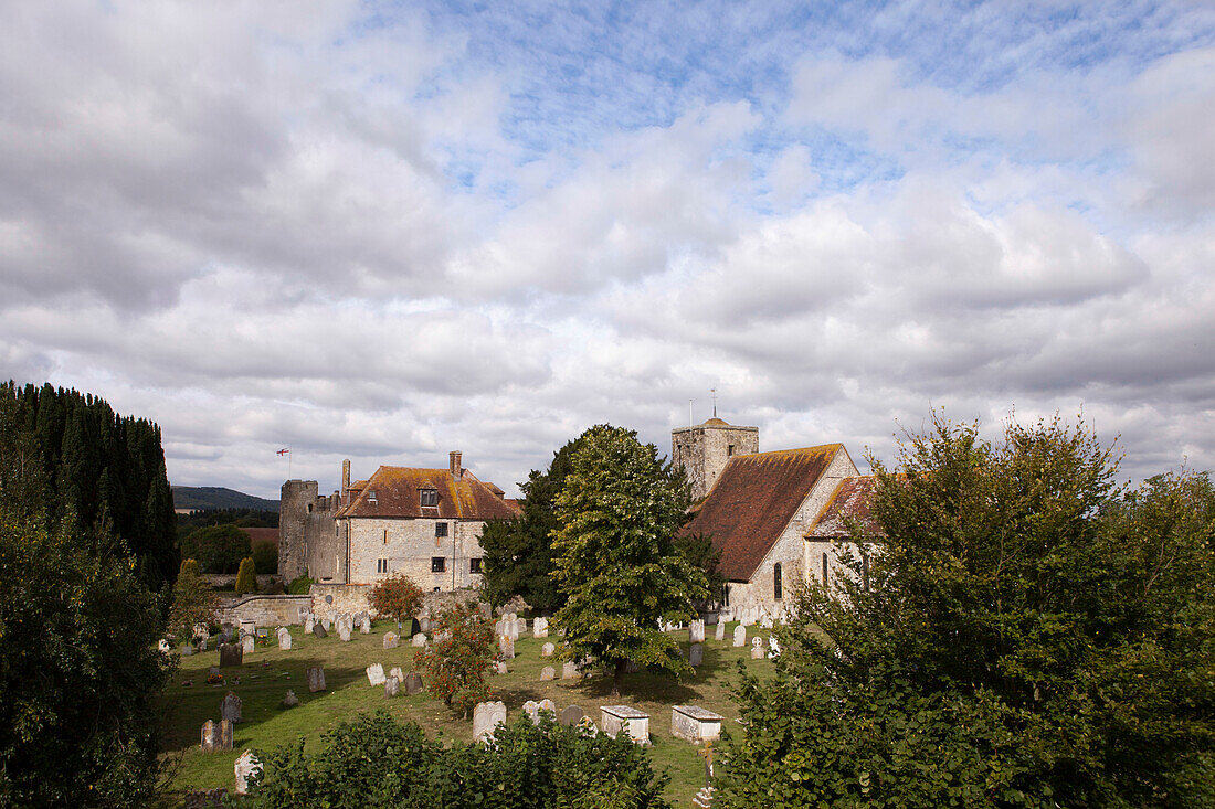 Tiled roof of church with graveyard in Amberley, West Sussex, England, UK