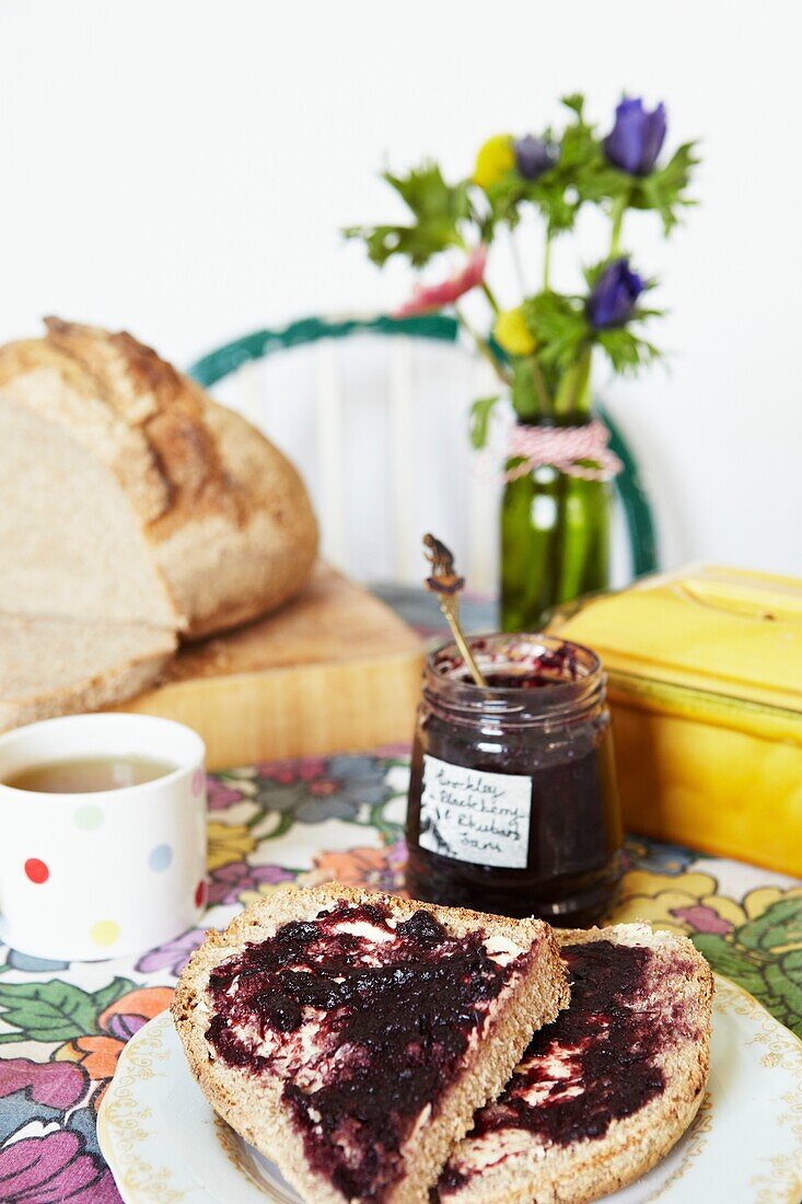 Jam on bread with a cup of tea,  London family home,  England,  UK