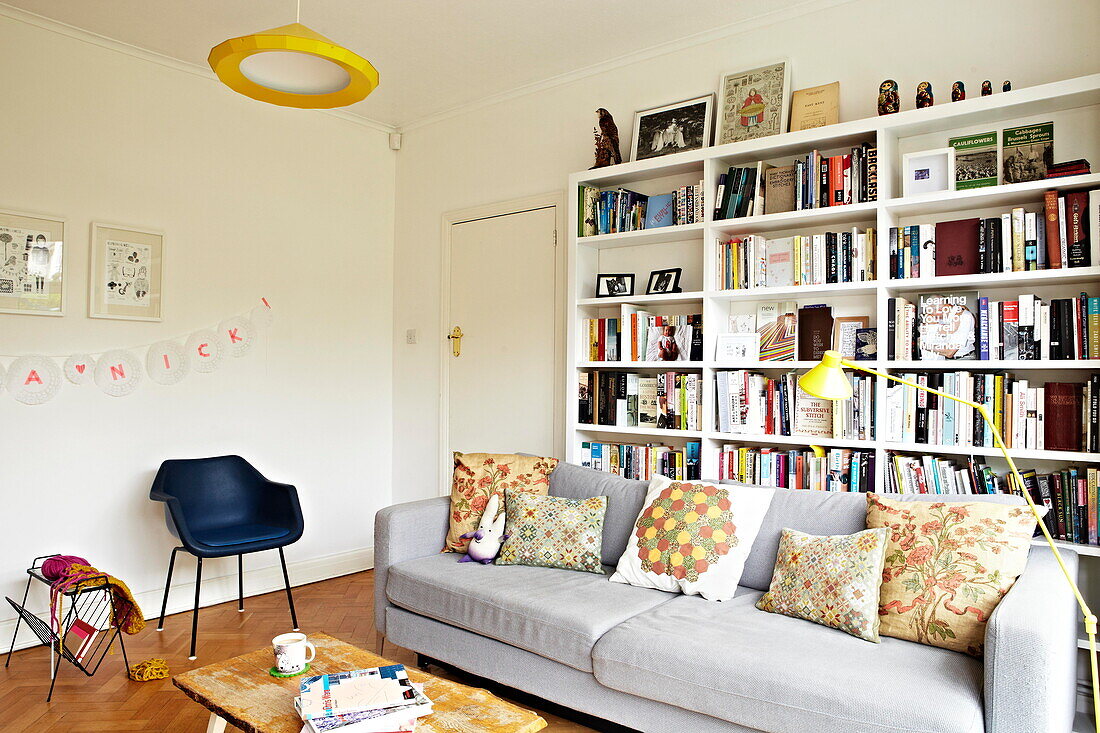 Large bookcase in living room of London family home  England  UK