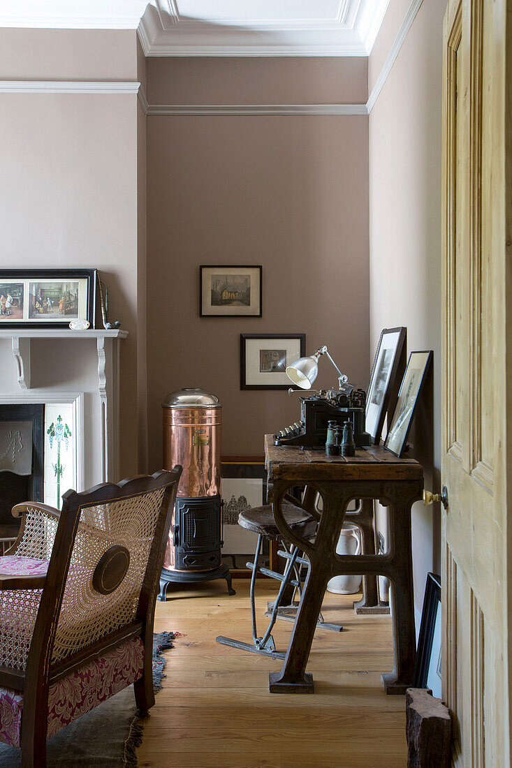 Industrial toolmaker?s bench and copper stove in Edwardian West Sussex townhouse England UK