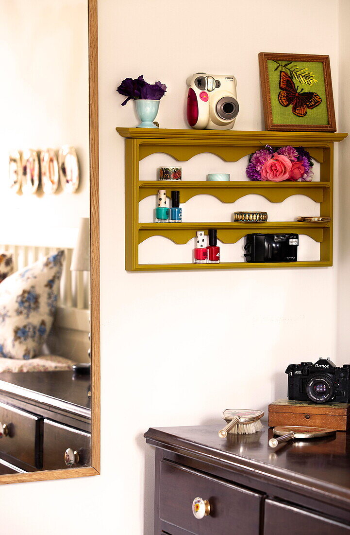 Wall mounted shelving and mirror in bedroom detail of Birmingham home  England  UK