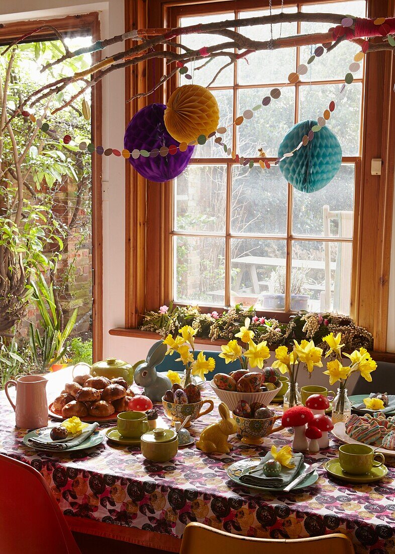 Daffodils on kitchen table with Easter decorations in London home   England   UK