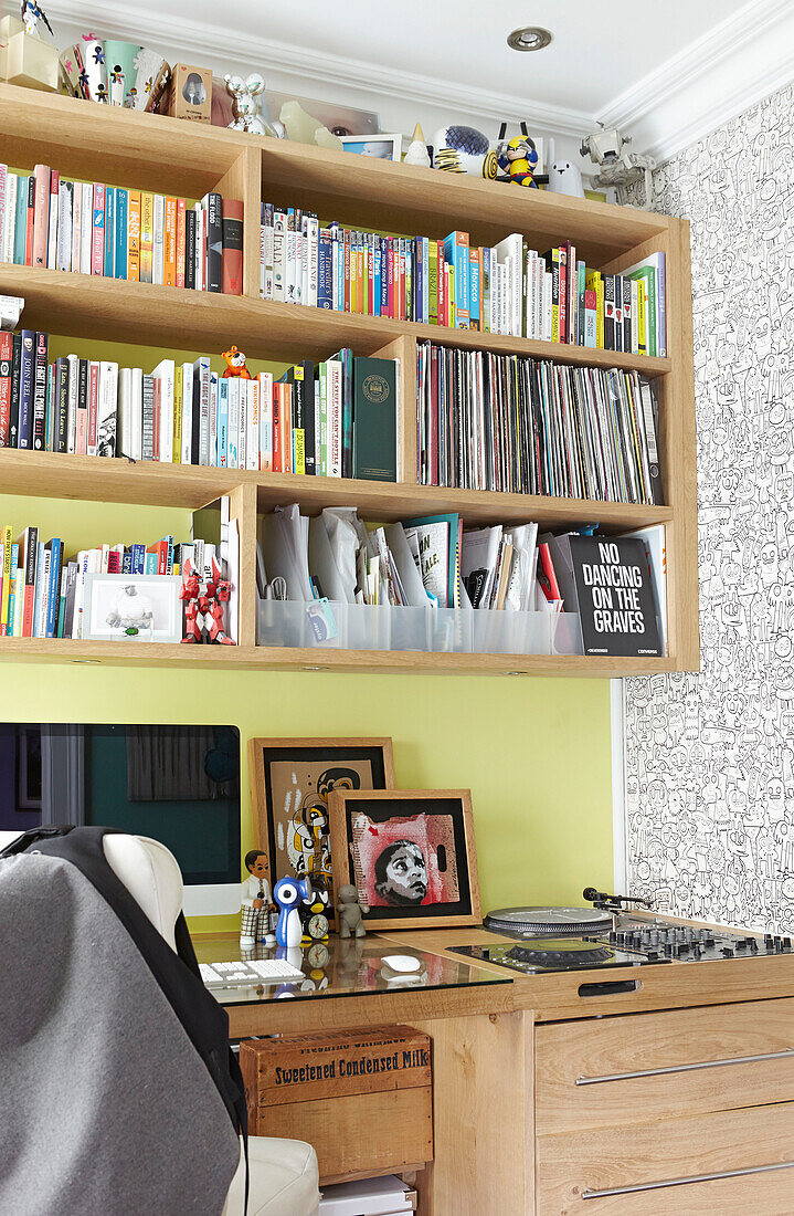 Wooden bookshelf above desk in London townhouse  England  UK