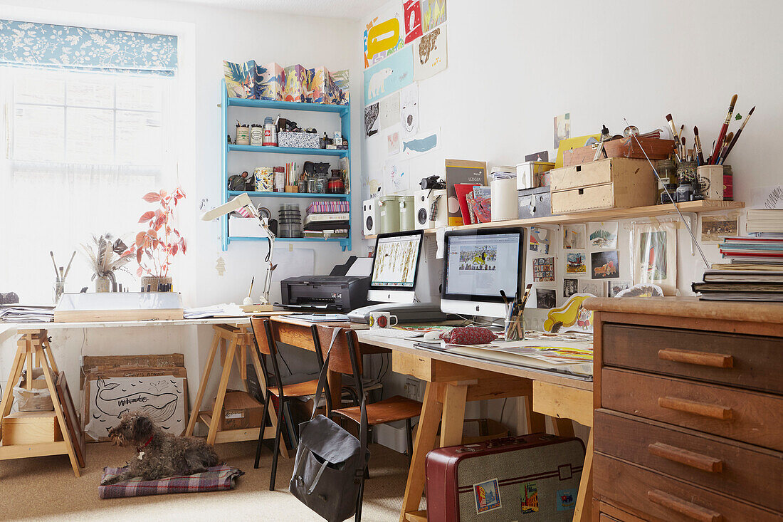 Computer screens on wooden desk with shelving in Berwick Upon Tweed home  Northumberland  UK