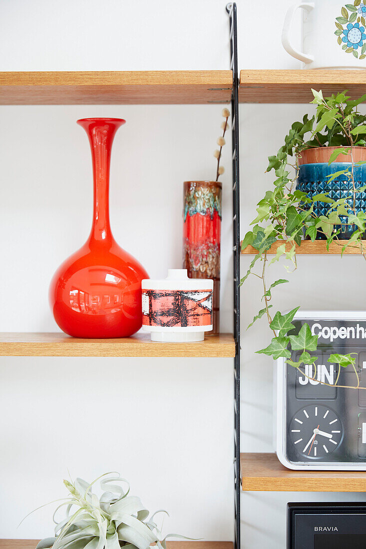 Retro style ornaments on wooden shelving in modernised Preston home  Lancashire  England  UK