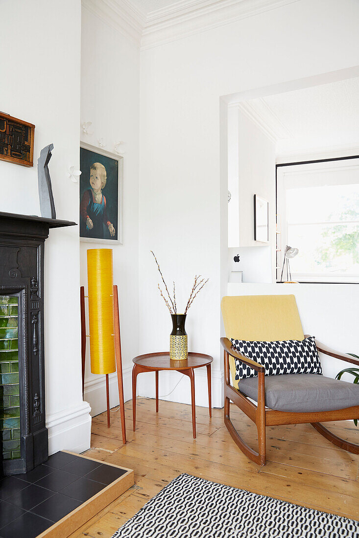 Vintage rocking chair and lamp with side table in modernised Preston home  Lancashire  England  UK