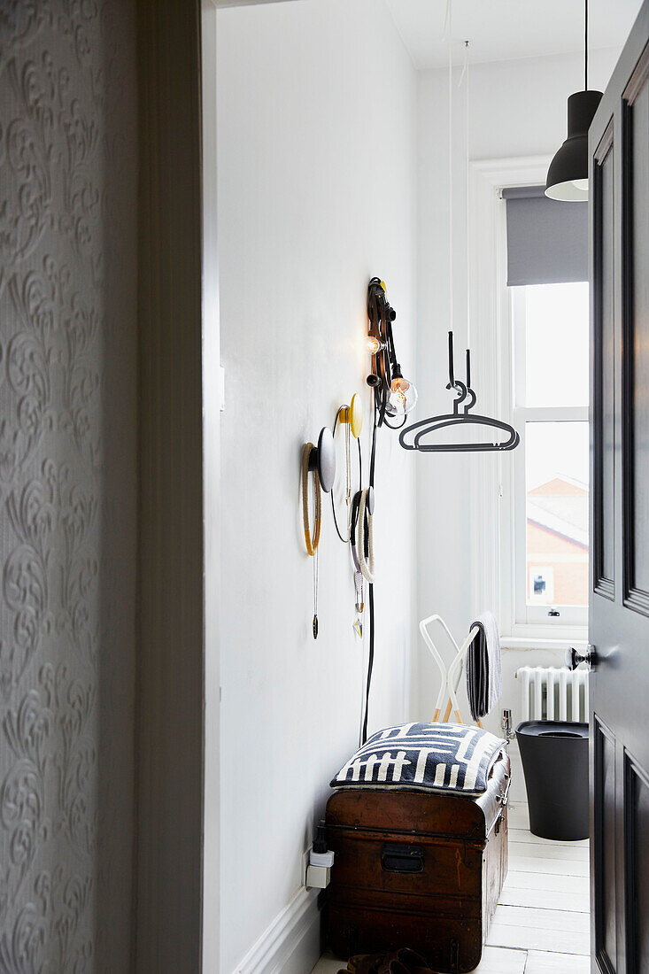 View through bedroom door to wall storage above chest in modernised Preston home  Lancashire  England  UK