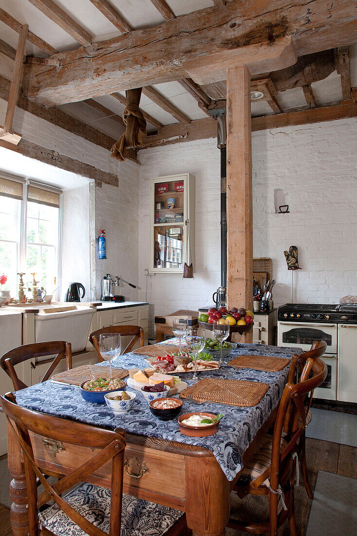 Placemats and lunch dishes on table in kitchen of watermill conversion