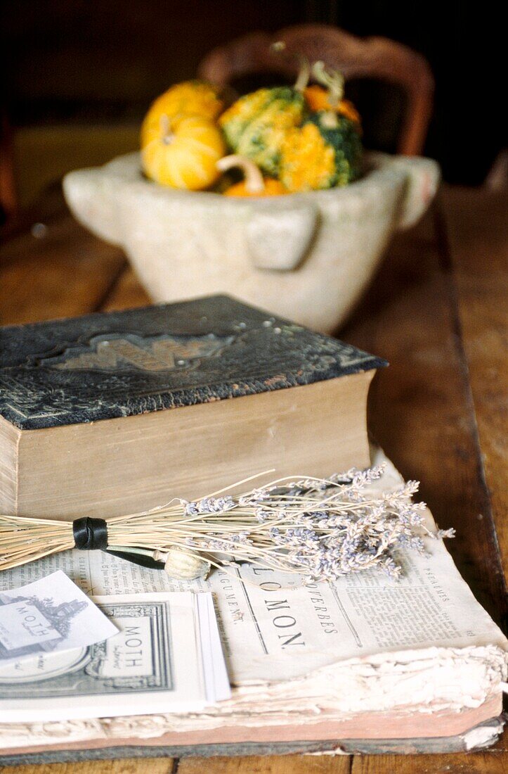 Still life of antique books squashes and lavender