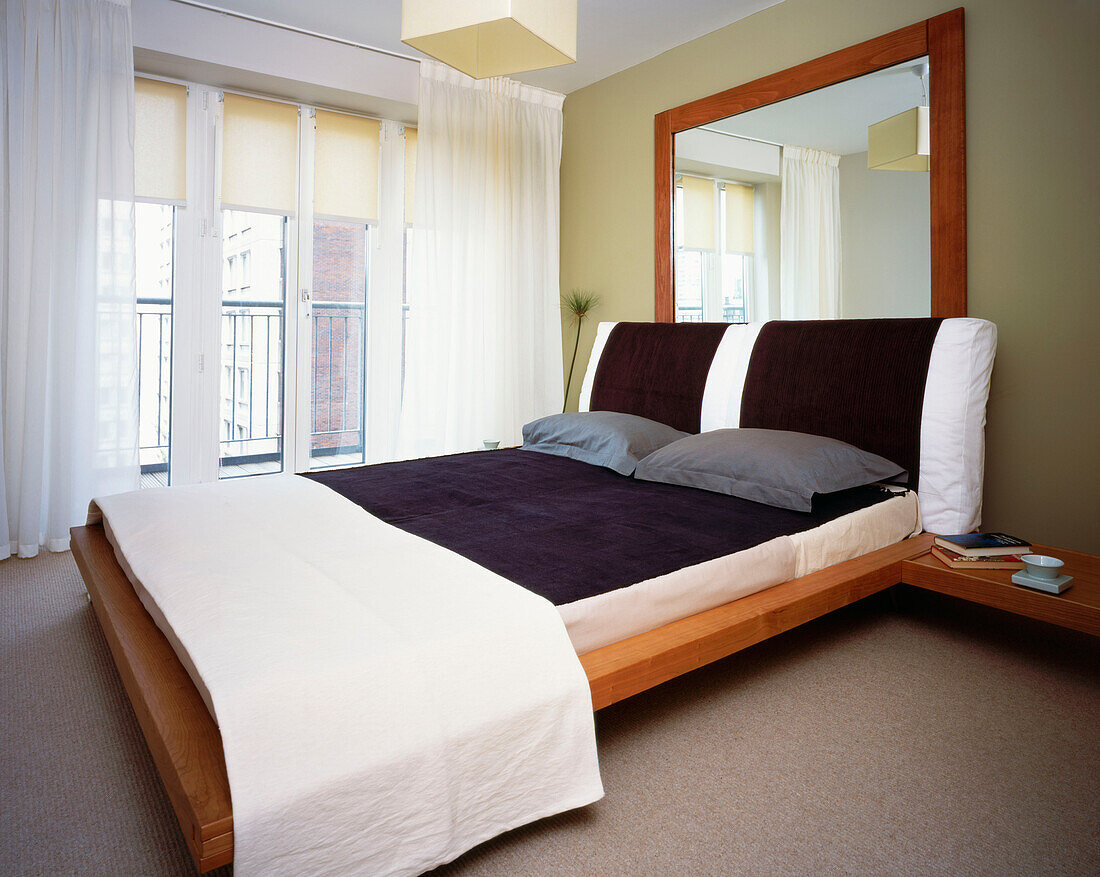 Double bedroom with monochrome decor and window with balcony