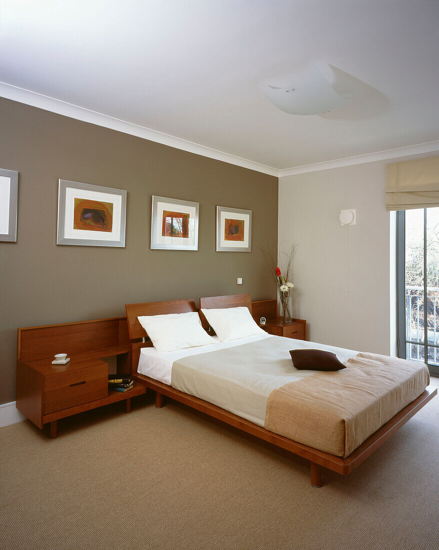 Master bedroom with modern furnishings and dark grey feature wall