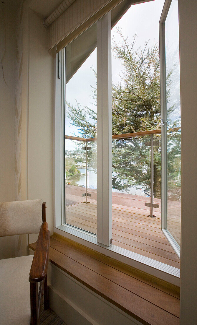 Window opening on to balcony with waterside view