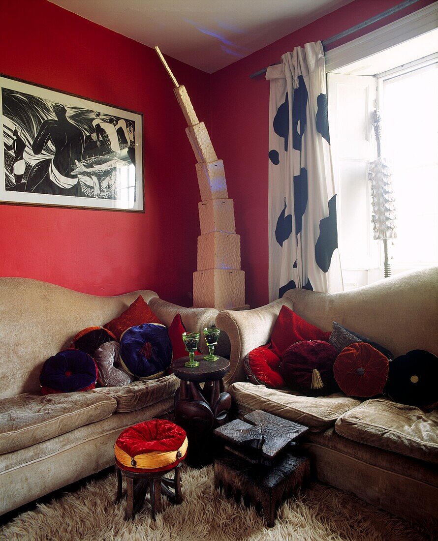 African style stools in carpeted red sitting room