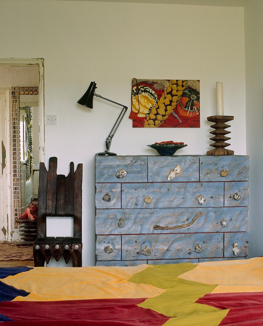 Main bedroom with hand built furniture and colourful quilt on bed