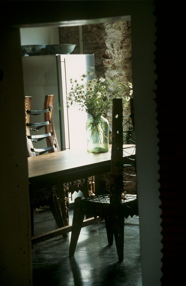 View into dining room with handcrafted wooden chairs